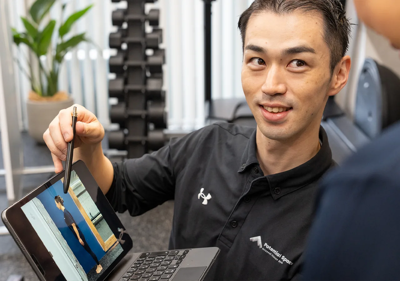 初回アセスメントで姿勢を確認するトレーナー